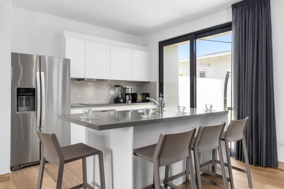 Start the day with coffee or end the night sipping wine on  this counter with sleek bar stools.