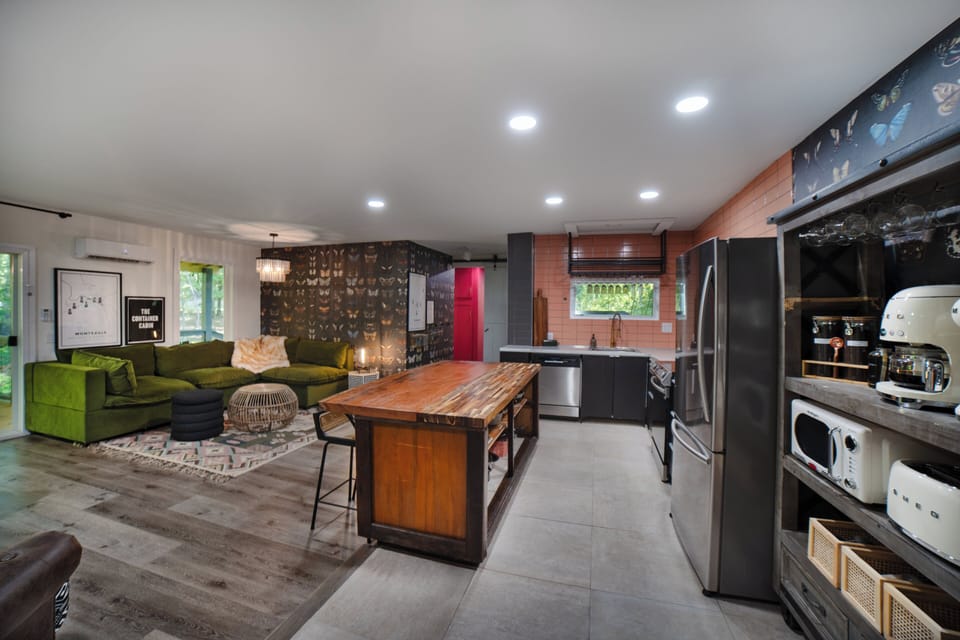 Left door walks out to 1 of 5 viewing decks, right pink hallway leads to bedroom 1, the 1st of 4 master suites. 