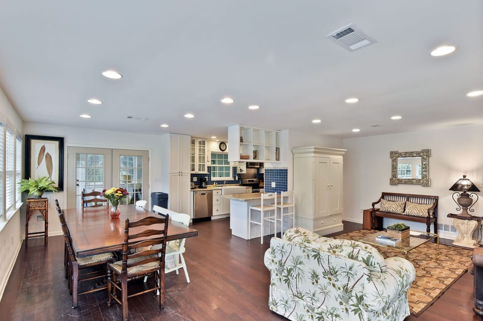 Dining Room with Long Table - Long dining table by French doors seats the group near the kitchen and living room.