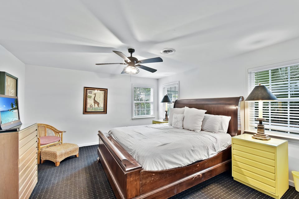 King Bedroom with Smart TV - King bedroom with smart TV, ceiling fan, natural light, and storage.
