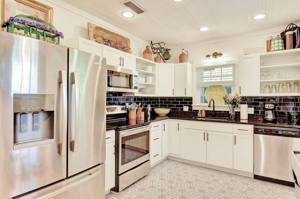 Updated Kitchen with Stainless Appliances – The Stumble Home - Whip up island feasts in the fully equipped kitchen at The Stumble Home, featuring stainless steel appliances, granite counters, a drip coffee maker, and plenty of space to gather, prep, and snack.