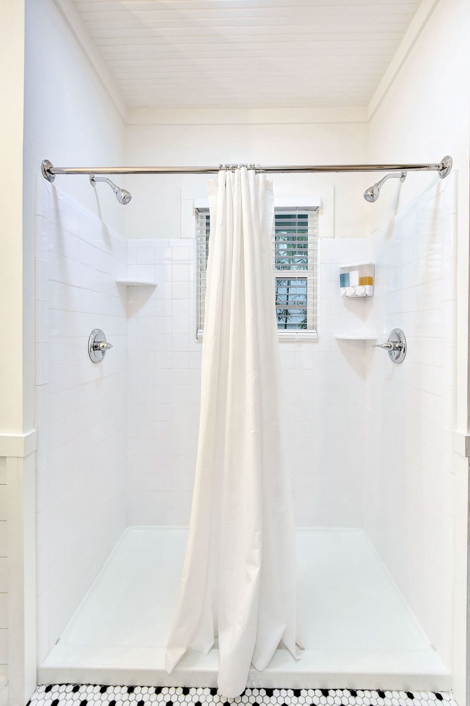 Walk-In Shower with Double Showerheads – The Stumble Home - Refresh in style with The Stumble Home’s bright walk-in shower, featuring dual showerheads, fresh tile, and natural light—the perfect setup after a day of island adventures.