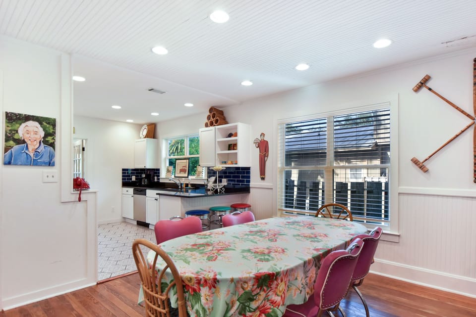 Kitchen And Dining Area With Seating For 6 - Dining table, breakfast bar, open shelving, and navy tile keep the kitchen and dining area connected.