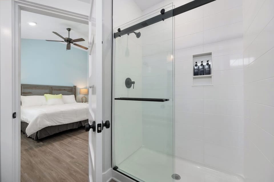 Modern bathroom with walk-in shower and fresh linens.