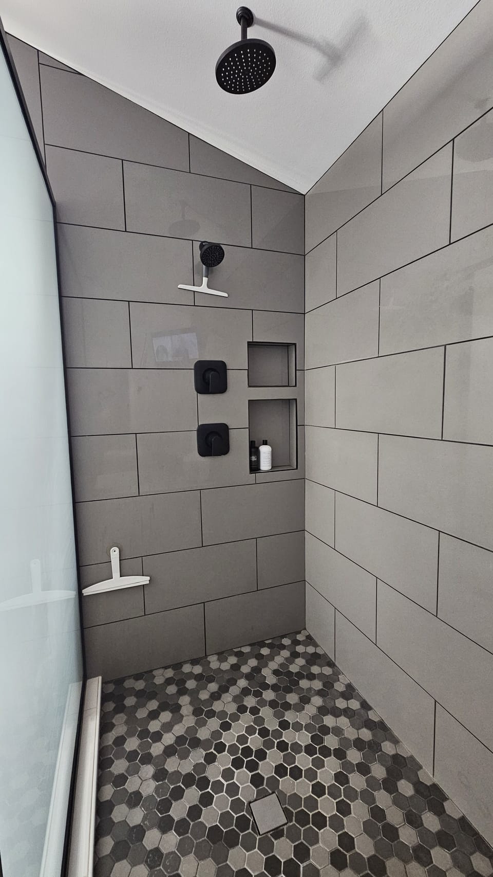 Extra large master shower has additional rain shower head. 