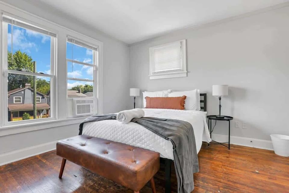 The main bedroom with natural light, warm tones, and a bed you won't want to leave