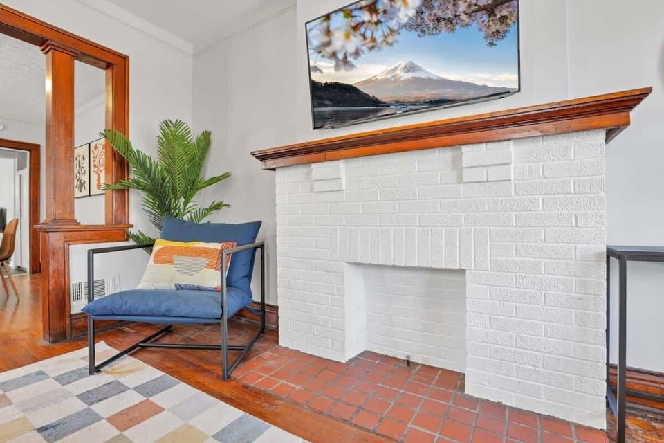 An inviting living area with original hardwood floors and vibrant accents