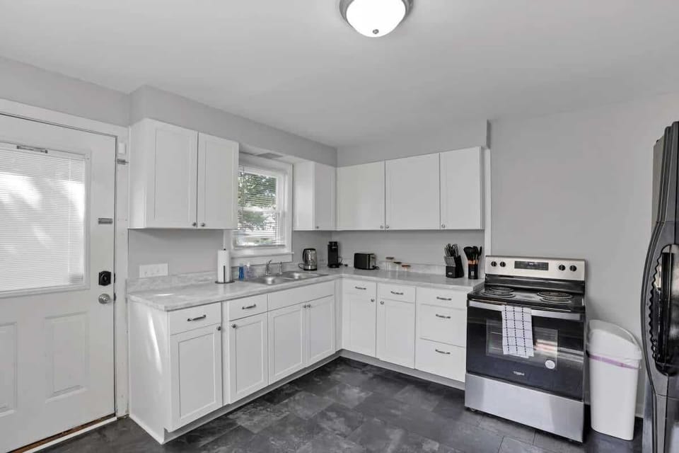 Clean white cabinetry and stainless appliances — a kitchen built for real meals