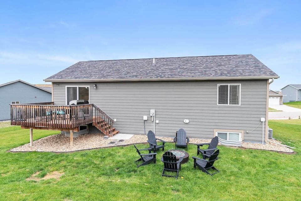 Expansive outdoor area featuring a patio and a fire pit, perfect for enjoying the great outdoors and gathering around a warm fire.