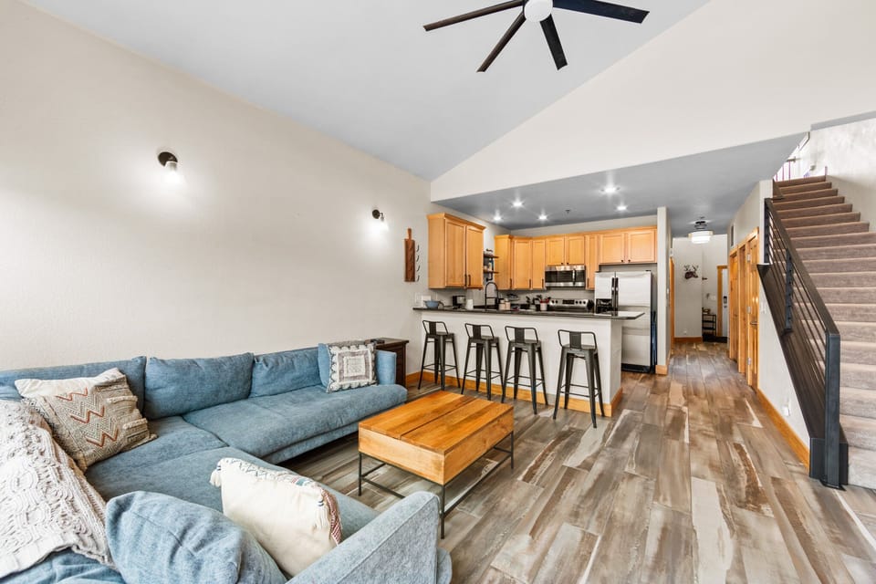 Relax in your spacious open-plan living area where the cozy sectional sofa flows into a modern kitchen perfect for cooking meals together.