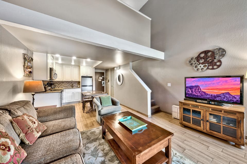 Unwind in your open-concept loft with soaring beams, modern kitchen, and entertainment center perfect for cozy movie nights together.
