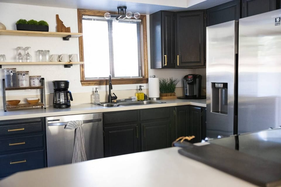 Prepare meals in a fully equipped kitchen featuring elegant gray accents and all the essentials for a comfortable stay