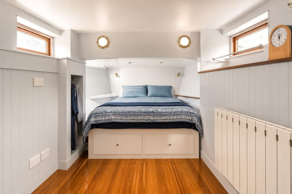The main cabin, with a queen bed and clever built-in storage below