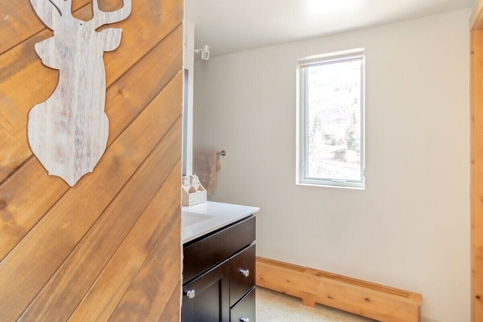 Upper-level bedroom features a king bed, vaulted ceilings and en-suite bathroom