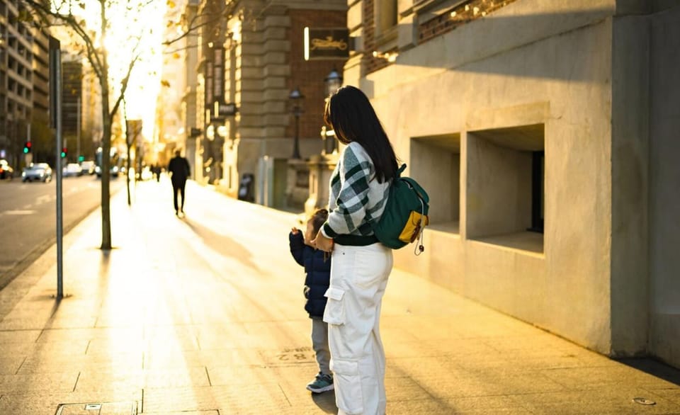 Stroll through golden-lit streets, where warm sunlight filters through the trees, casting a dreamy glow on the city. A peaceful walk filled with connection and quiet charm.