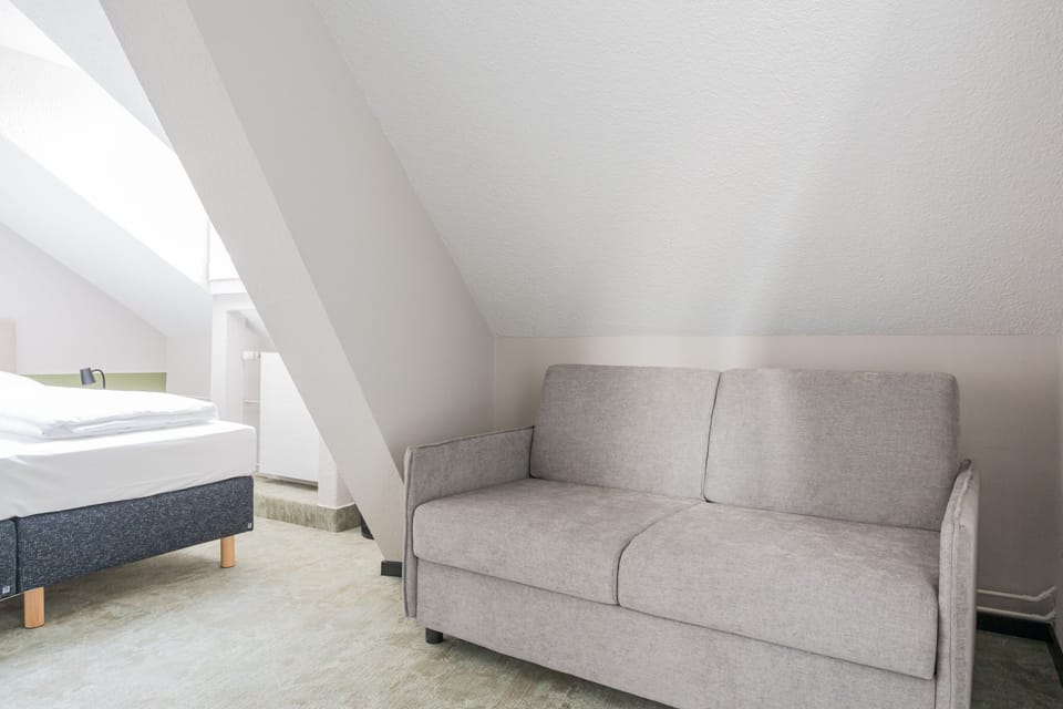 Deluxe Quadruple Room | Down comforters, in-room safe, desk, iron/ironing board