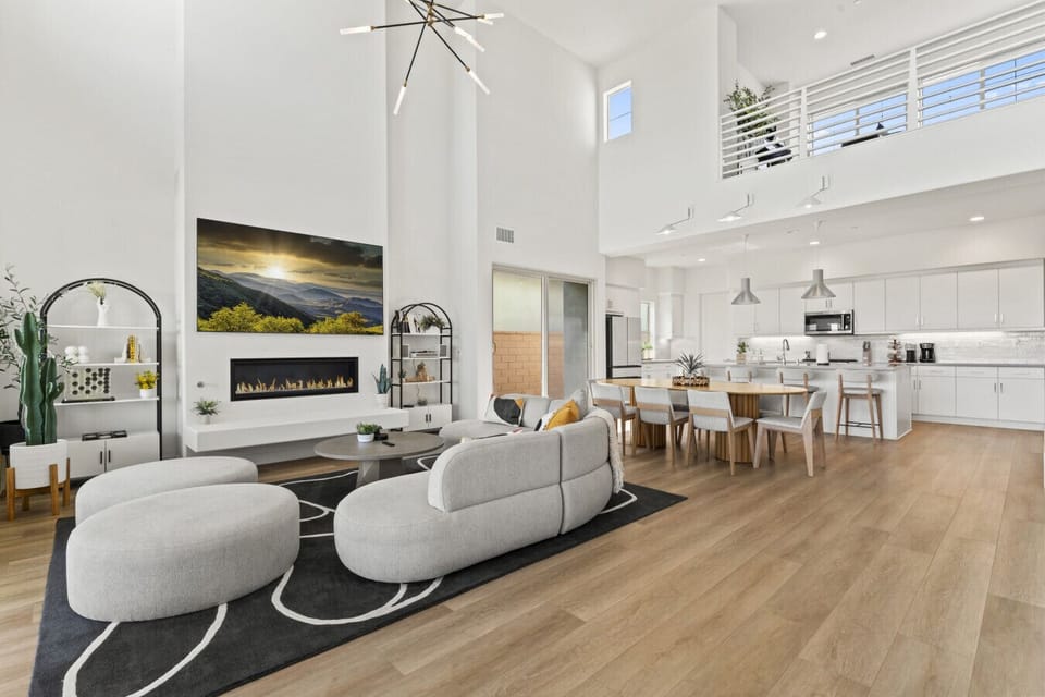 Bright open living space w/ soaring ceilings, cozy seating & seamless flow to the kitchen.