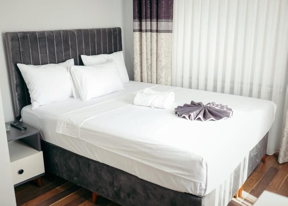 Desk, laptop workspace, bed sheets
