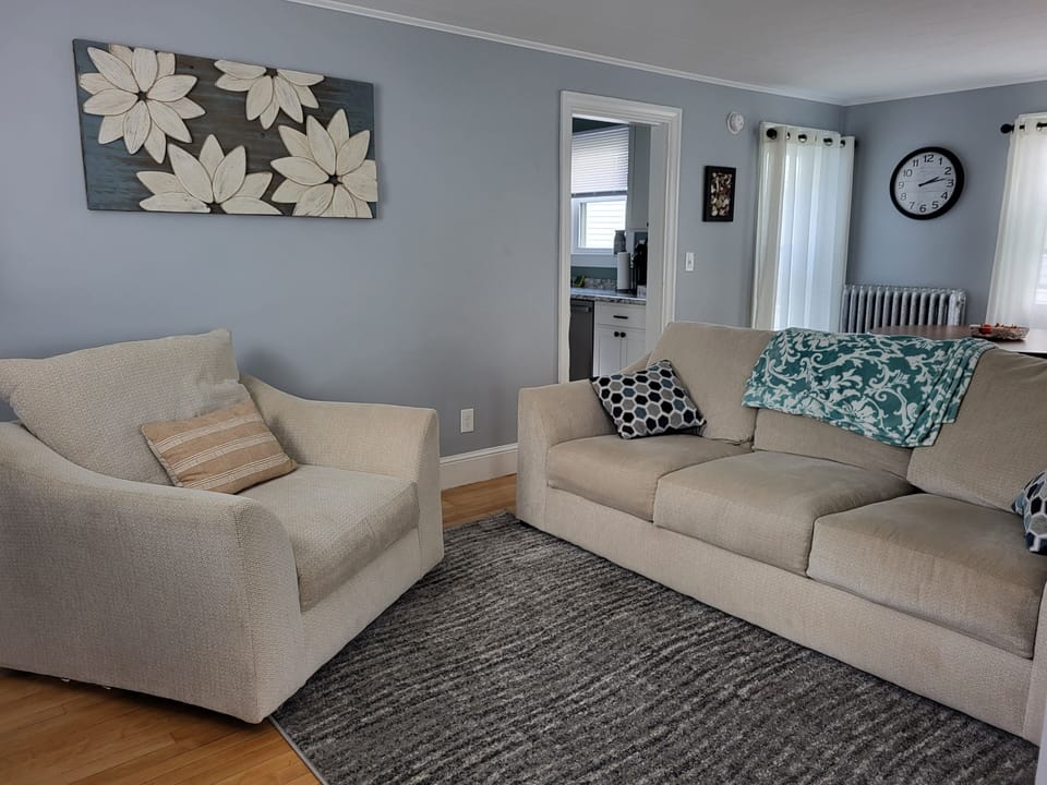 Living room with open concept to dining table. TV with Roku. 1st floor