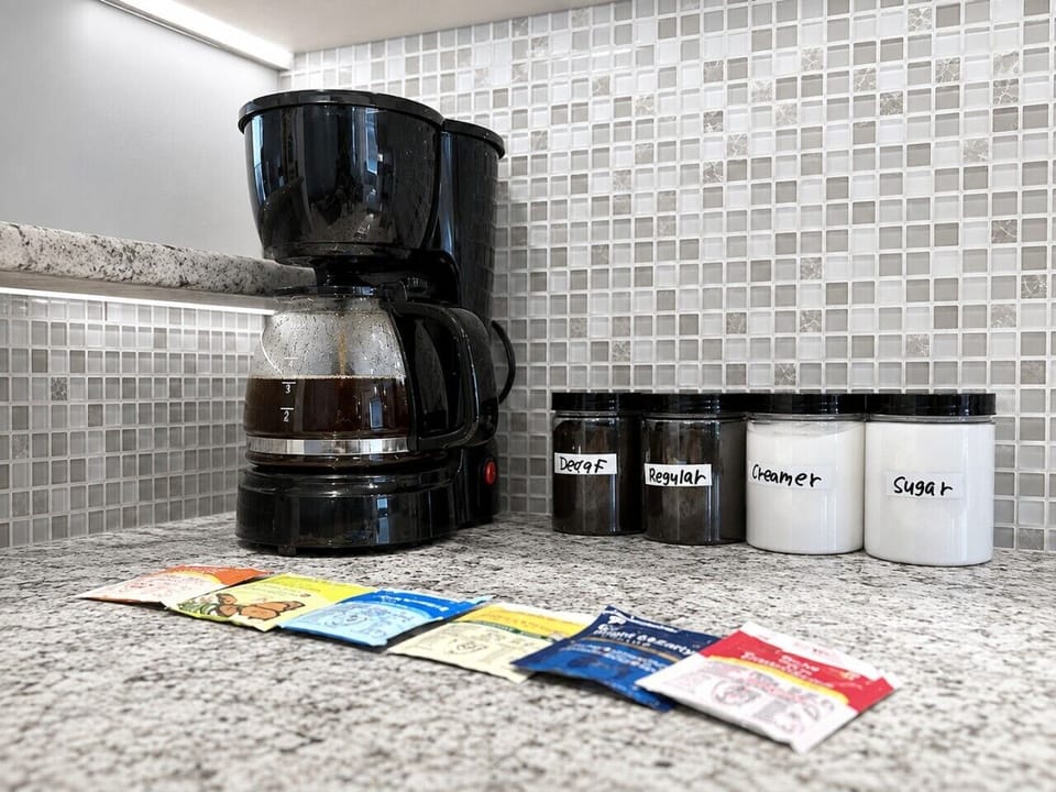 Coffee pot with coffee, decaf, sugar, and creamer and mixed teas