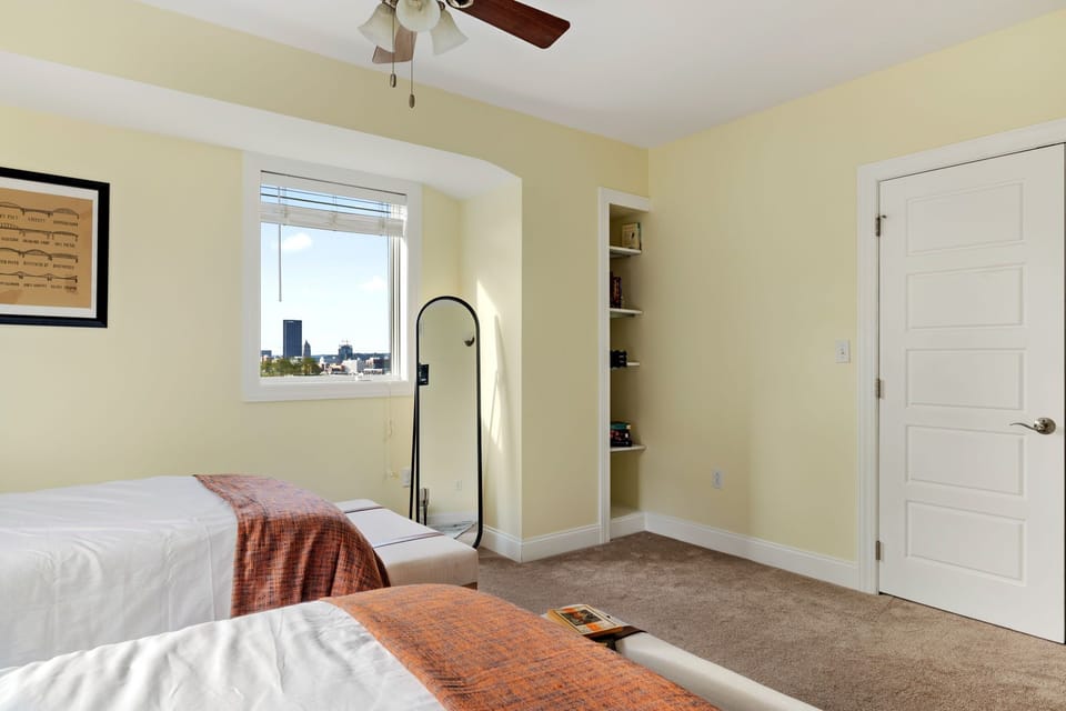 A bedroom equipped with a mirror and a storage rack