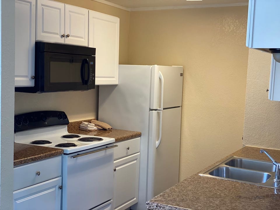Full kitchen with appliances and cooking essentials 