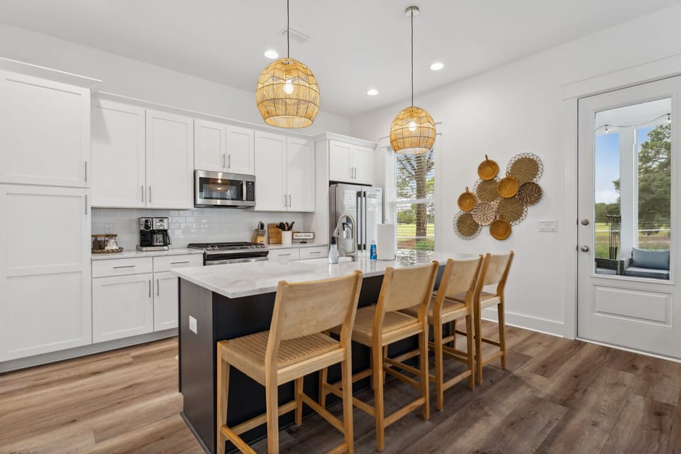 Large island for all your cooking and hosting needs in fully stocked kitchen.
