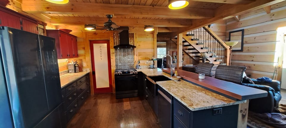 Kitchen with new modern appliances.  Direct vent and pantry. Live edge teak bar
