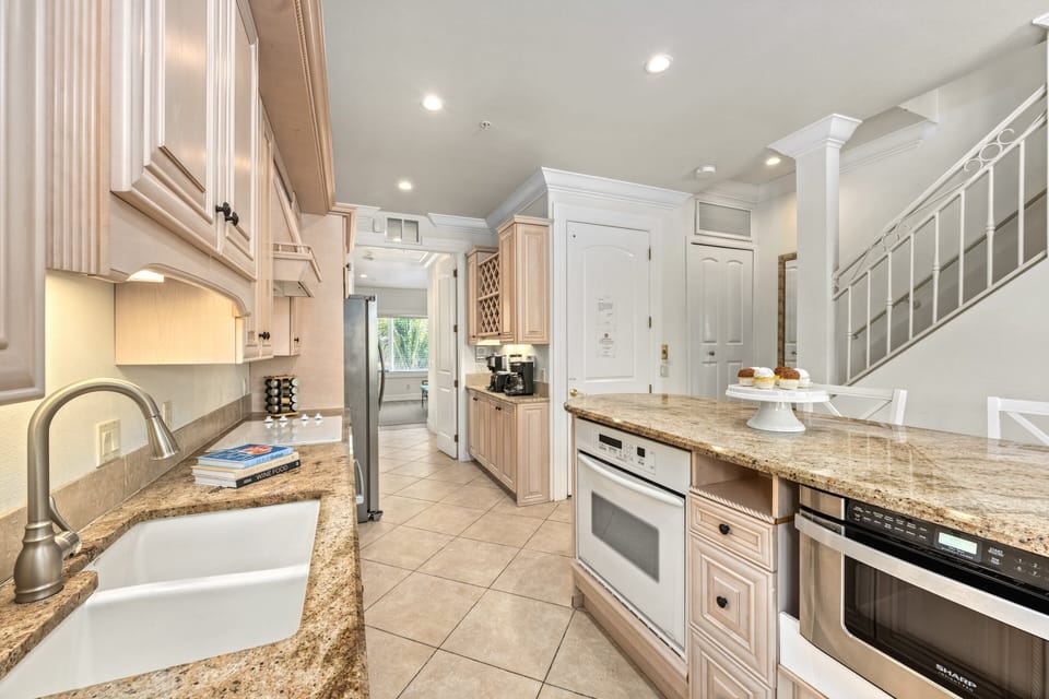 The kitchen with double sink and modern appliances.
