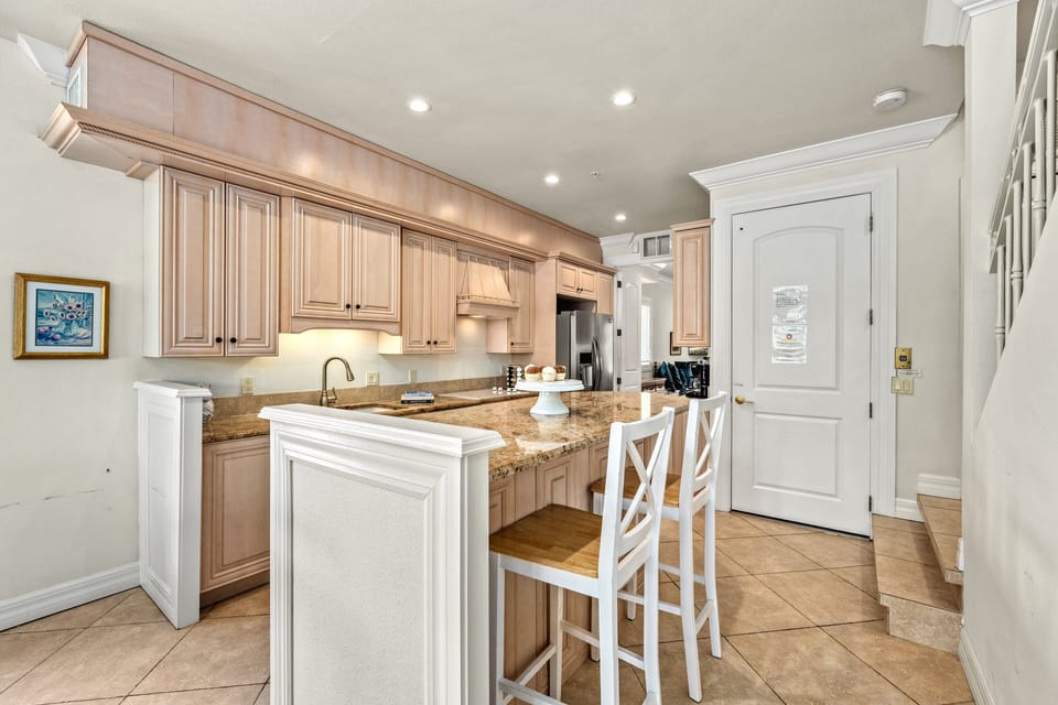 Kitchen with center island and breakfast bar.