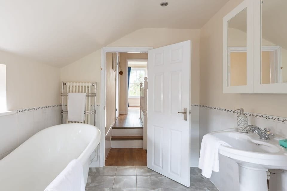 A well-spacious bathroom with towel-heated rack