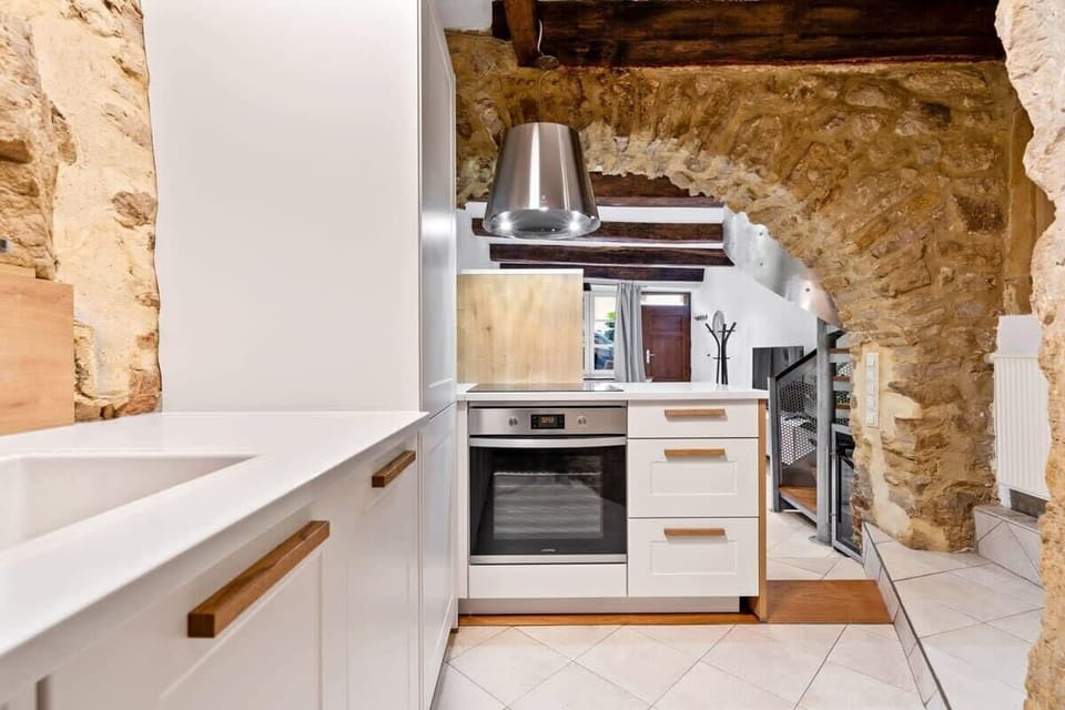 Fully equipped kitchen blending modern appliances with historic stonework, offering everything you need to cook comfortably during your stay.