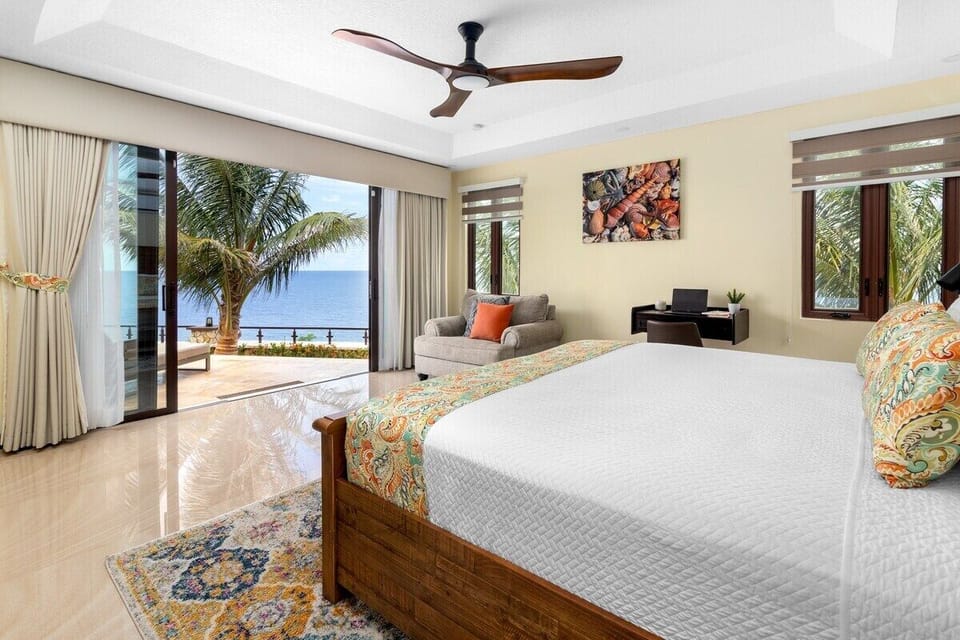 Downstairs East 
From this main bedroom you walk out unto the pool deck, equipped with prestine white bed linen, AC, Smart TV, a large closet and personal office space. Enjoy the amazing views from the comfort of your King bed.