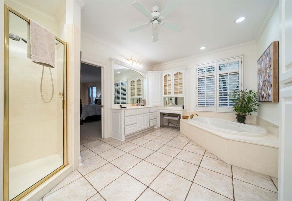 [Primary Bathroom] The Primary Bathroom has a Large Bath Tub, a Spacious Sink Area, a Walk-In Shower, and Plenty of Natural Light to Make Getting Ready a Breeze.