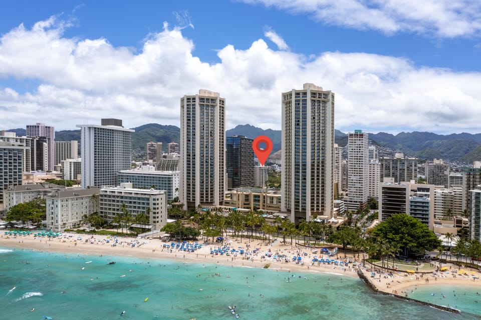 This beachfront property sits steps from the turquoise waters of Waikiki, with towering mountains framing the backdrop and vibrant city energy all around.
