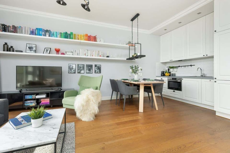 A closer angle on the seating area, emphasizing the wooden floor, colorful decor, and open layout.
