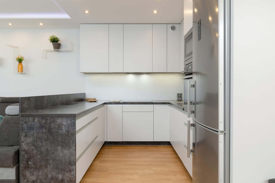 Intimate kitchenette with natural light from nearby windows.