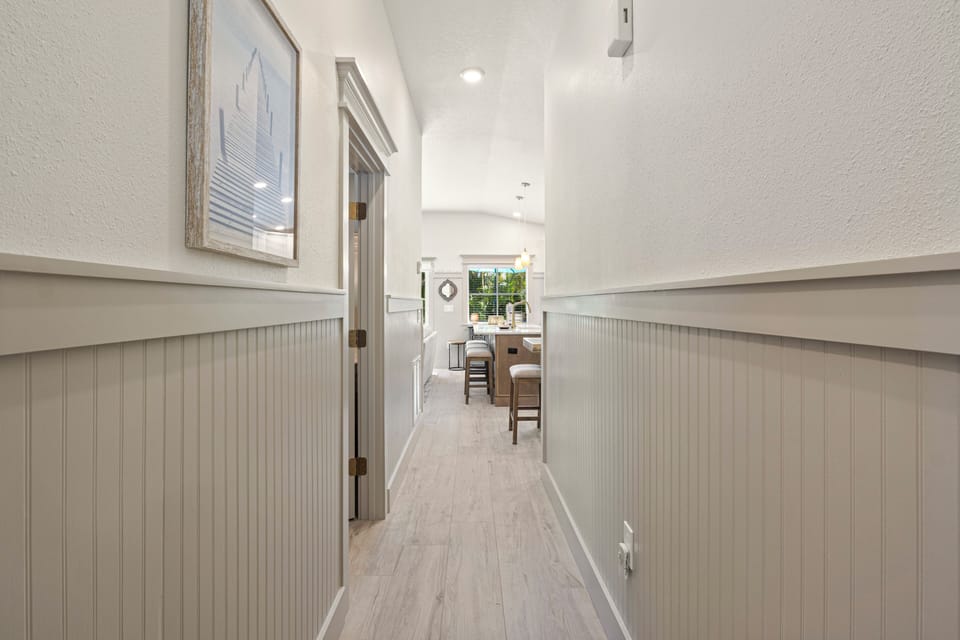 Step into your welcoming hallway where coastal charm meets modern comfort, leading you to bright spaces filled with natural light.
