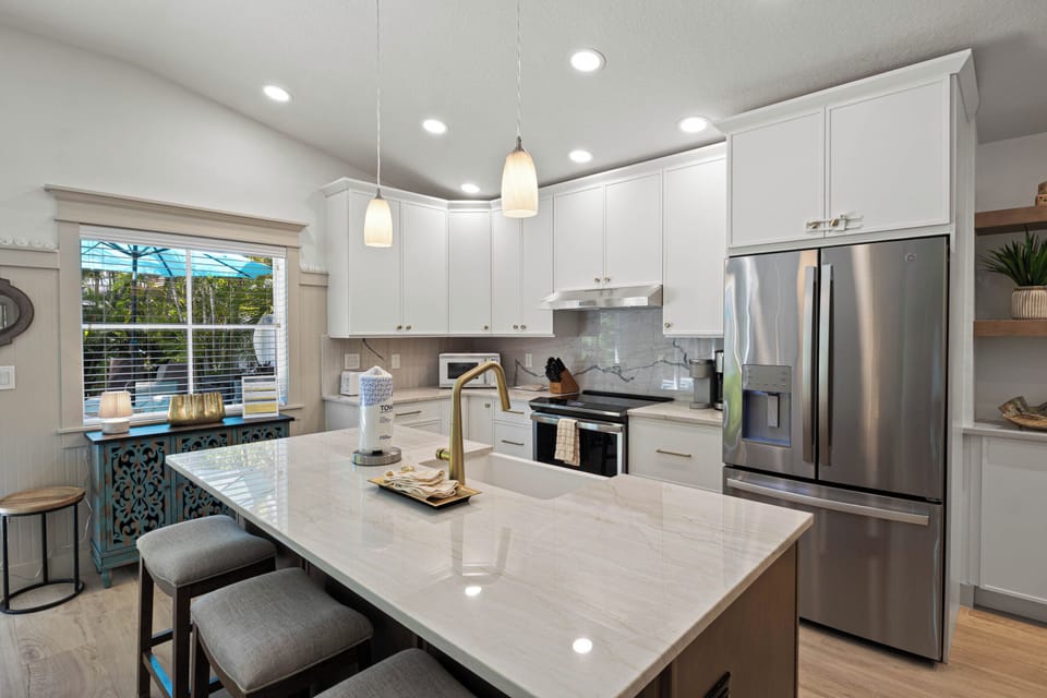 Your bright, modern kitchen awaits with sleek appliances and elegant quartz countertops—perfect for preparing memorable meals during your stay.