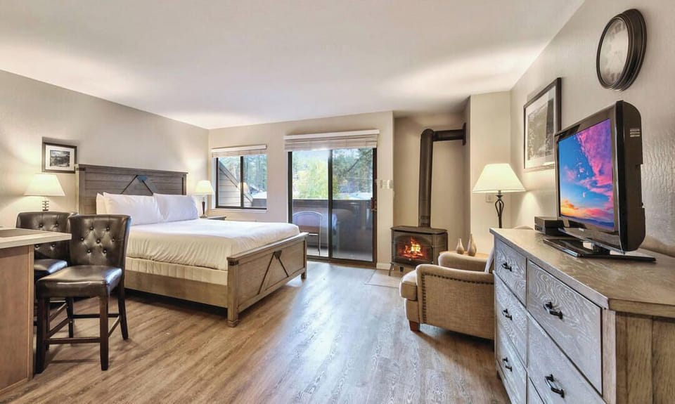 Unwind in your cozy retreat featuring rustic furnishings, a crackling fireplace, and modern amenities for the perfect mountain getaway.