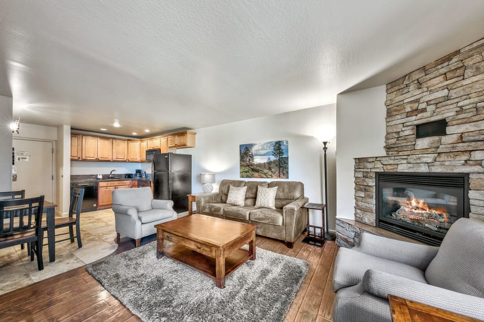 Cozy up in your spacious living area with stone fireplace, full kitchen, and comfortable seating for memorable evenings together.