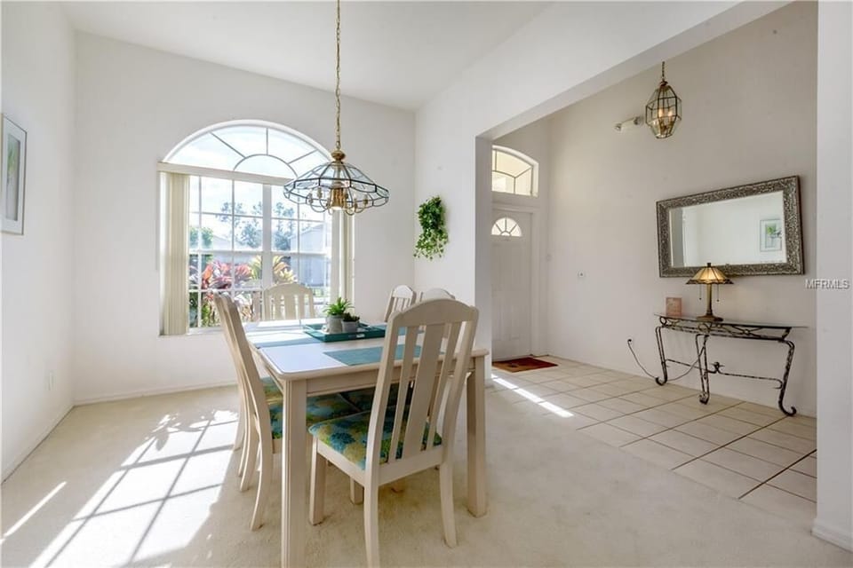 Elegant dining area with large windows for a bright and cheerful ambiance.