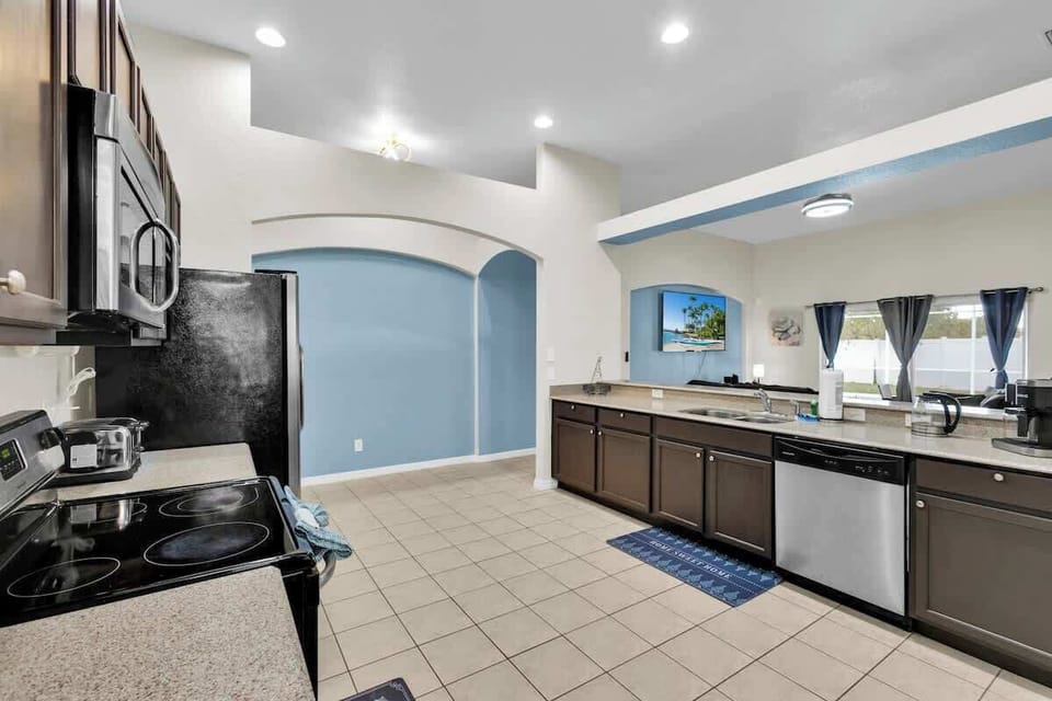 A kitchen that blends convenience and style, offering expansive countertop space, a time-saving dishwasher, and a Keurig coffee machine for those perfect wake-up moments.