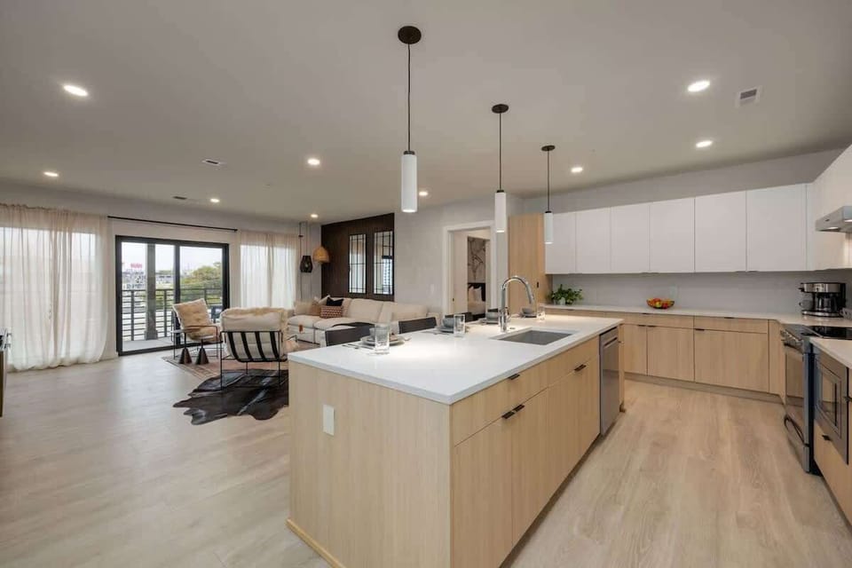 Kitchen stocked with all culinary essentials and fully equipped with brand-new stainless-steel appliances. Features an island with bar seating.