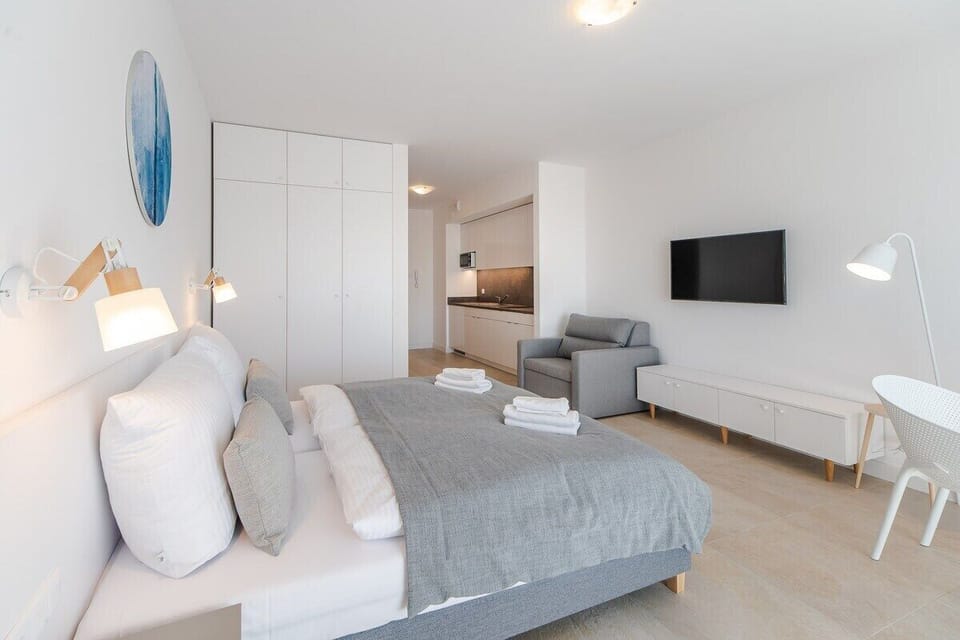 A cozy bedroom with a clean design, featuring bright accents and a serene ambiance.

