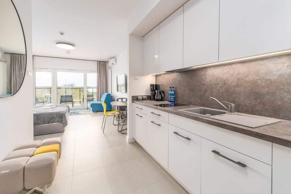 Bright kitchenette with cooking utensils. 
