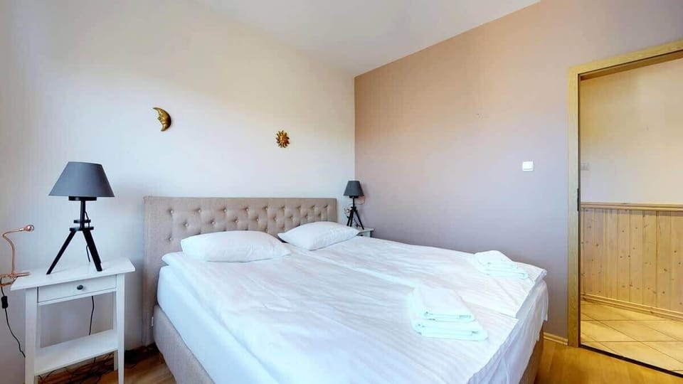 A cozy bedroom with a double bed, soft lighting, and neutral tones for a relaxing atmosphere.
