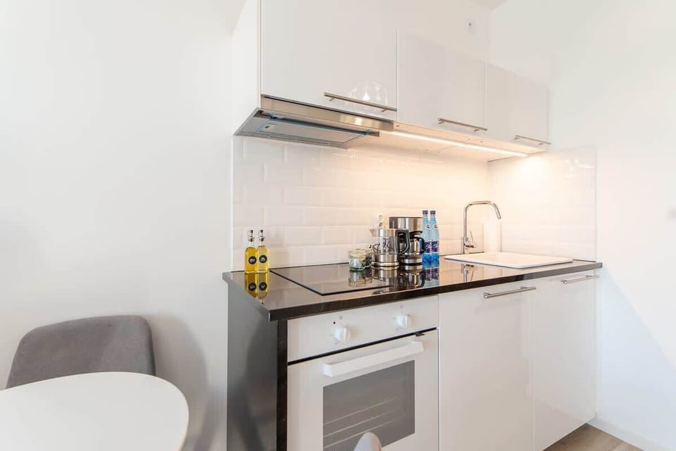 The sleek design of the kitchenette blending seamlessly with the living area.