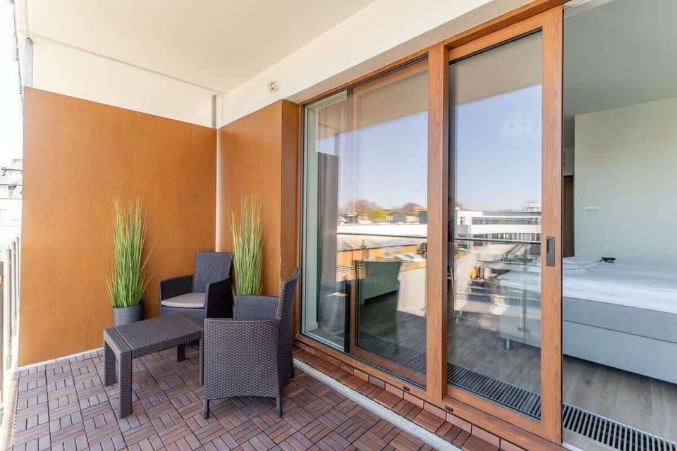 The balcony's stylish design complements the apartment's decor. 