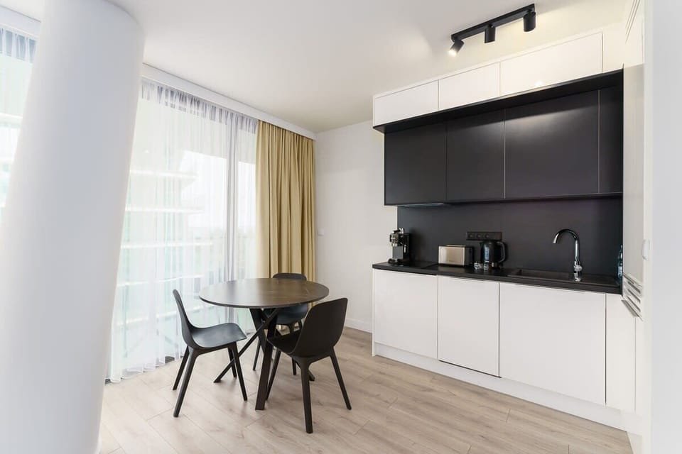Kitchenette with plenty of kitchen utensils and dishes. 